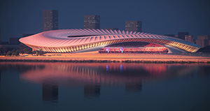 Photorealistic render of a stadium design with a large expanse of water in the foreground. The stadium is white with a large curved roof.